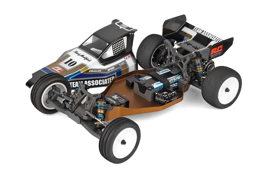 Team Associated 1/10 scale 2WD RC buggy chassis with bronze anodized aluminium deck, electronics, and black, blue, and silver retro-styled body shell.