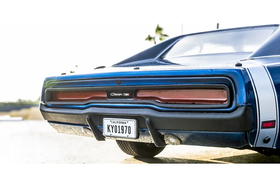 Rear close-up view of the blue Kyosho 1970 Dodge Charger RC car showing taillights, bumper, and California license plate.