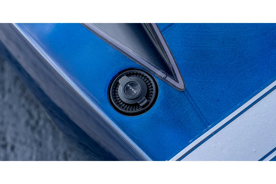 Close-up detail shot of the simulated fuel cap and side window trim on the blue body of the Kyosho 1970 Dodge Charger RC car.