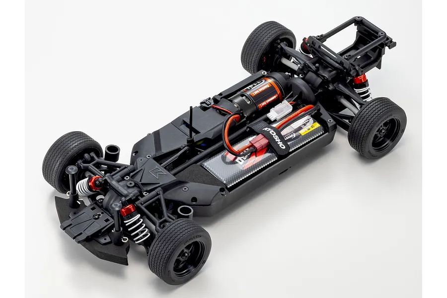 Top down studio view of the black composite chassis for the Kyosho Fazer MK2 RC car, featuring installed motor, battery, and suspension.