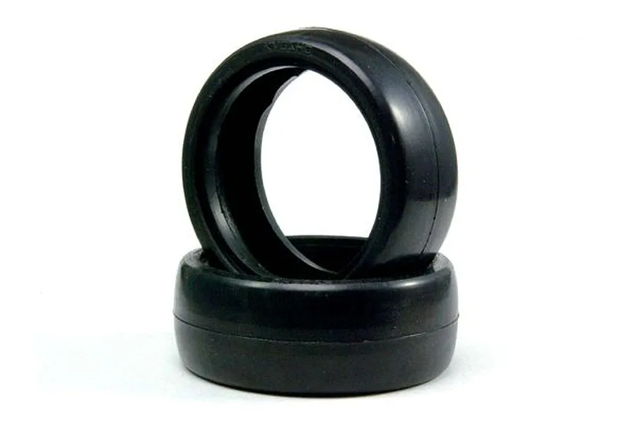 Two black slick RC car tyres stacked against a clean white background.