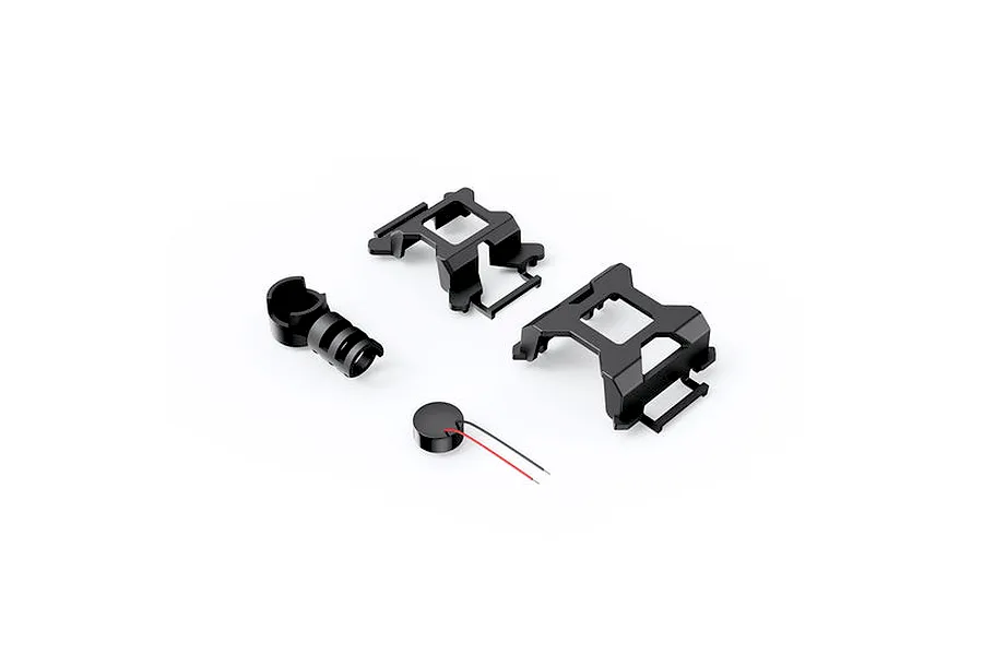 Studio product view of black plastic drone frame parts, mount components, and a buzzer with wires on a white background.