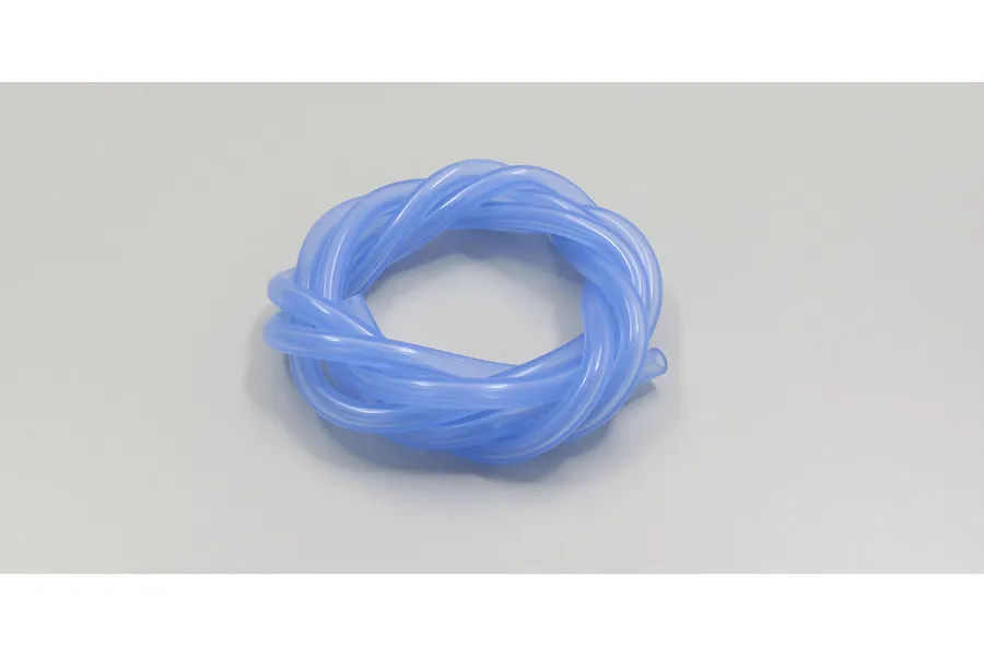 A coiled blue silicone fuel tube for RC nitro engines resting on a plain light grey studio background.