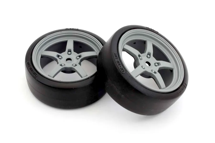Two Kyosho FZ02 drift tyres mounted on grey 5-spoke rims against a clean white background.