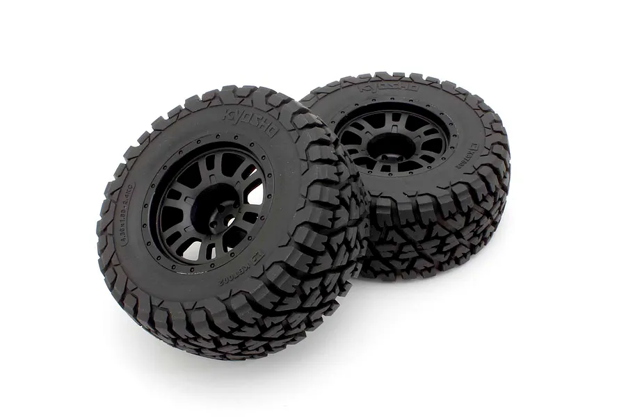 Two black RC monster truck tyres mounted on black multi-spoke rims against a clean white background.