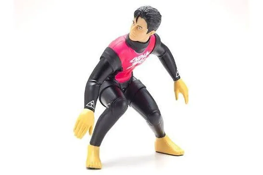 Kyosho 1/8 scale RC surfer figure wearing a black and pink wetsuit in a crouching stance.