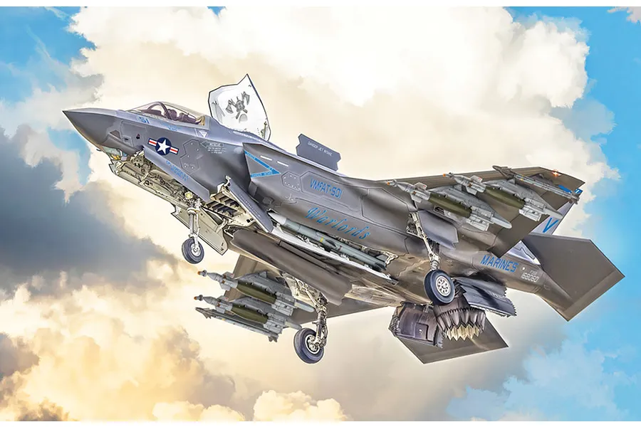 Painted plastic model kit of an F-35B Lightning II fighter aircraft in flight against a cloudy sky background.