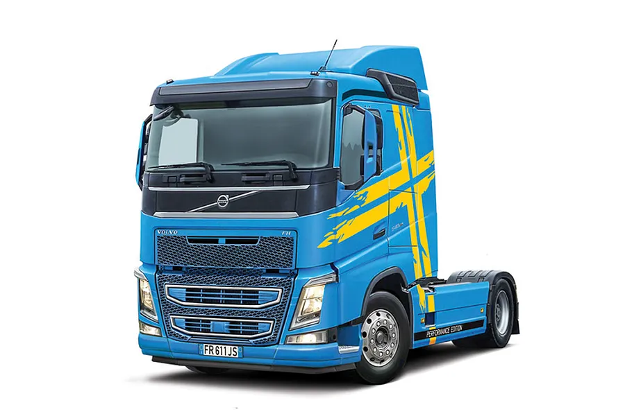 Completed Italeri 1/24 Volvo FH truck model painted blue with yellow Swedish cross graphics against a white background.