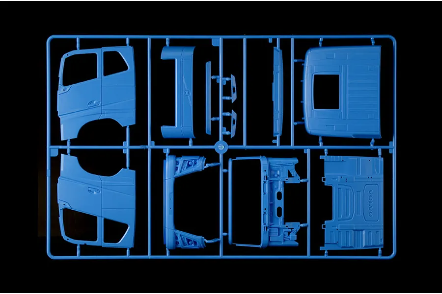 Blue plastic model kit sprue containing truck cab body parts and panels for the Italeri Volvo FH truck model.