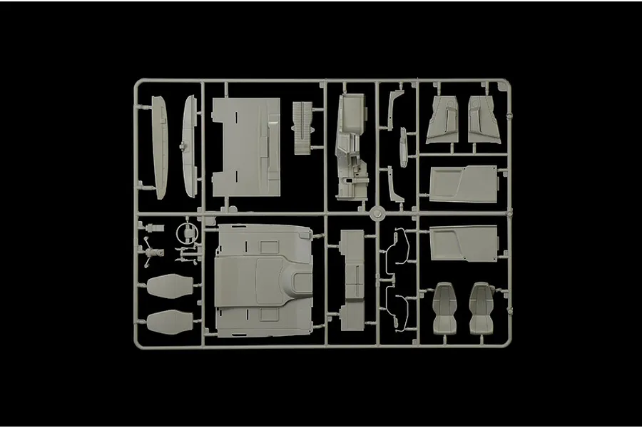 Grey plastic model kit sprue featuring various interior and exterior truck parts against a black background.