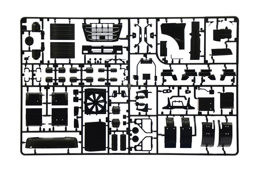 Black plastic model kit parts sprue featuring various truck components like grilles, panels, and engine parts on a white background.