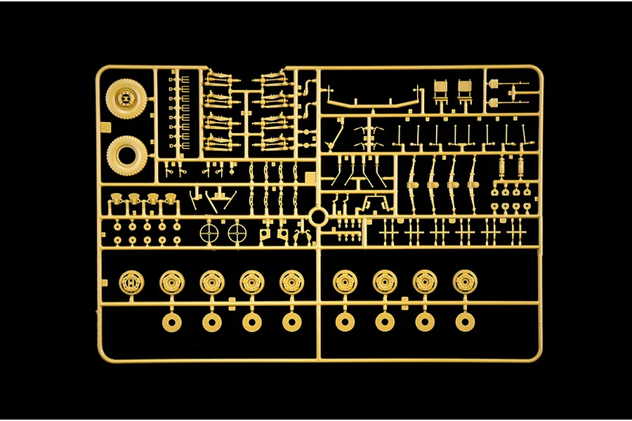 Tan plastic model sprue featuring various vehicle suspension and wheel parts on a black background.