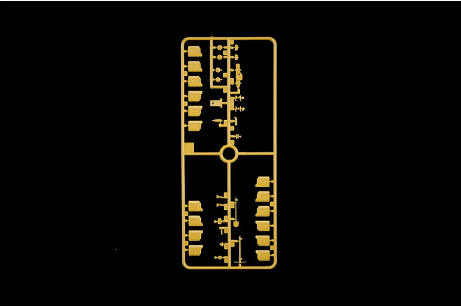 Tan plastic model kit sprue containing jerry cans and vehicle accessory parts on a black background