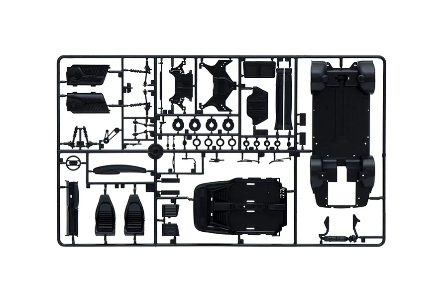 Black plastic model kit parts sprue containing chassis, interior components, seats, and suspension parts.