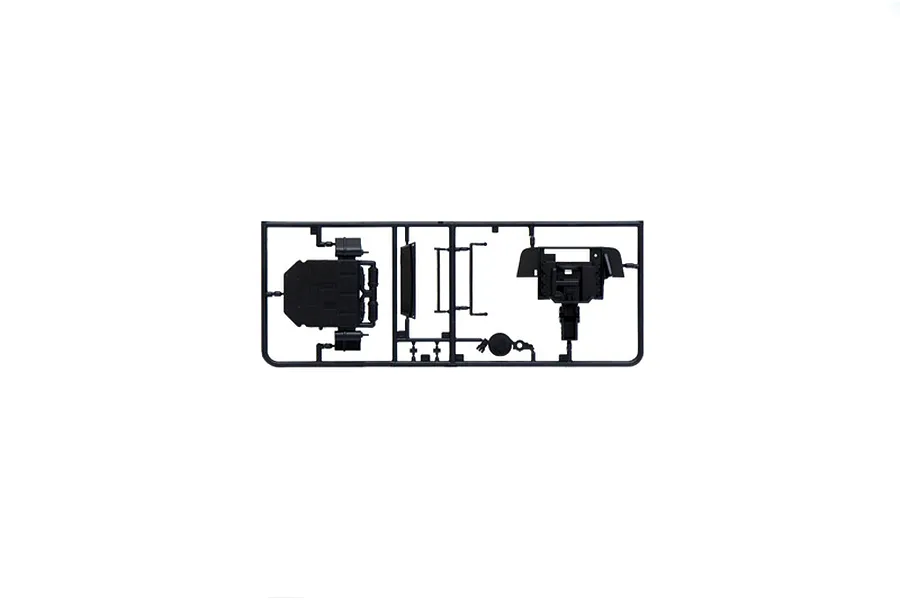 Black plastic model kit parts sprue on a clean white background