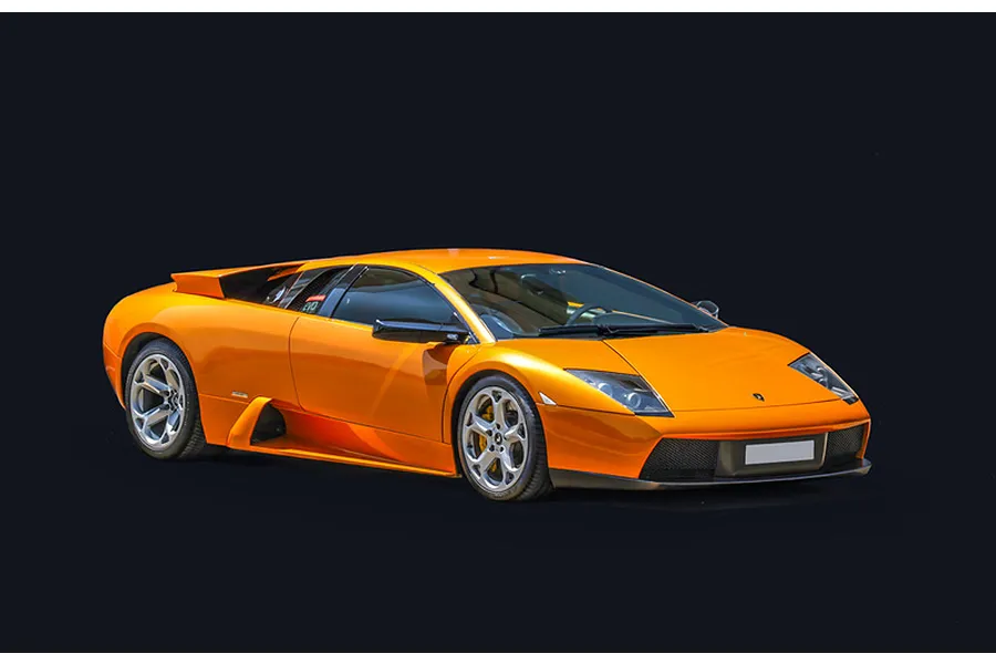 Studio photo of a finished orange Lamborghini Murcielago supercar model car against a plain black background.