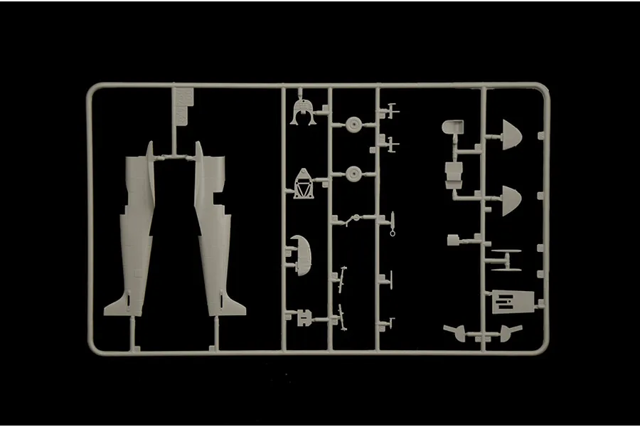 Grey plastic model kit sprue containing aircraft fuselage halves and interior parts against a black background.