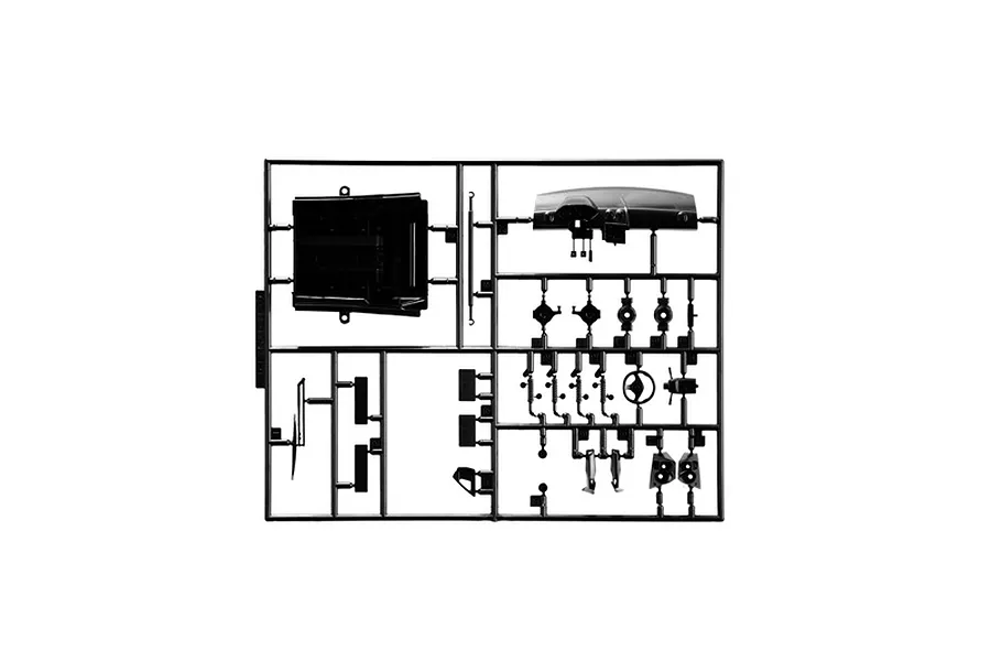 Black plastic model kit parts sprue featuring interior components like a dashboard and steering wheel on a white background.
