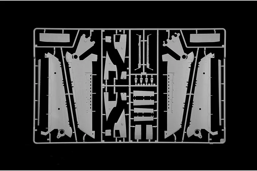 Grey plastic model kit parts sprue featuring aircraft wing sections and structural components on a black background.