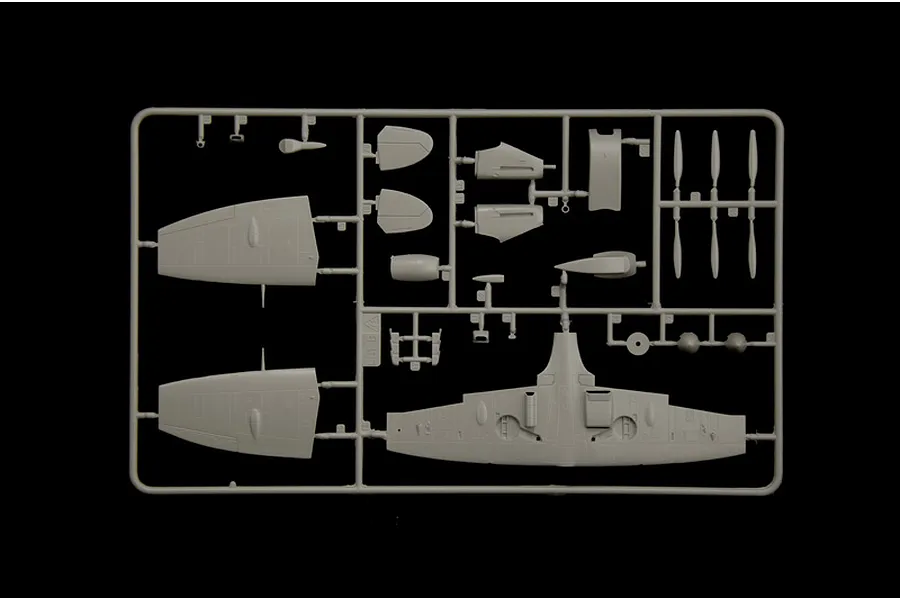 Grey plastic model kit sprue containing wings, propeller blades, and fuselage parts for the Italeri Spitfire.