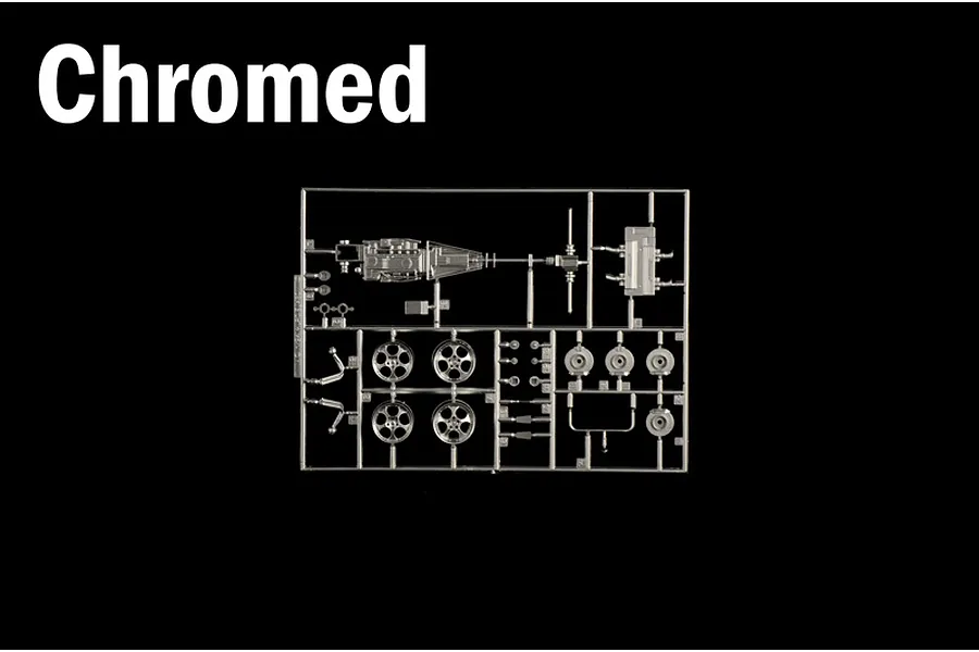 A sprue of chromed plastic parts including wheels and mechanical components for a model kit against a black background.