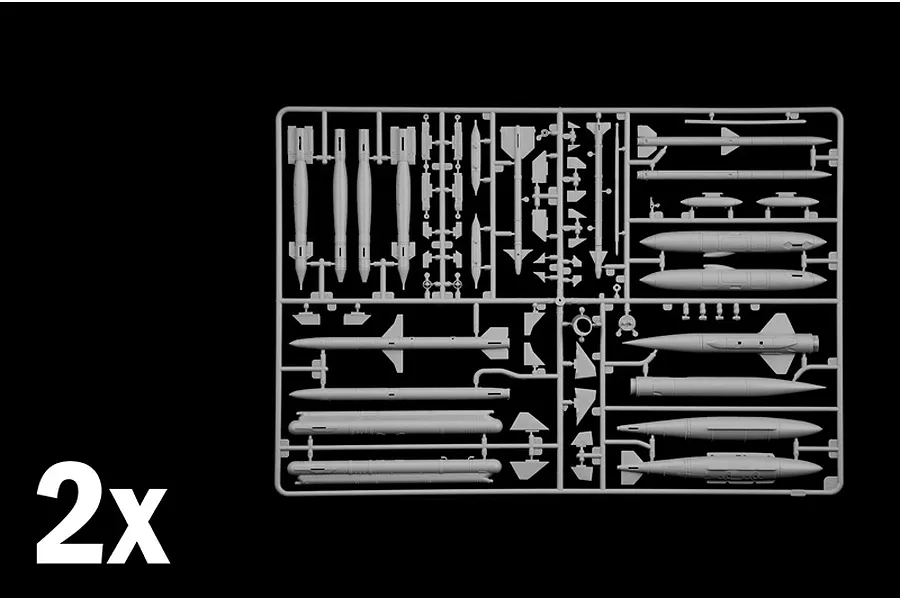 Grey plastic model kit sprue containing various weapon parts and missiles, labeled with a 2x indicator in the corner.
