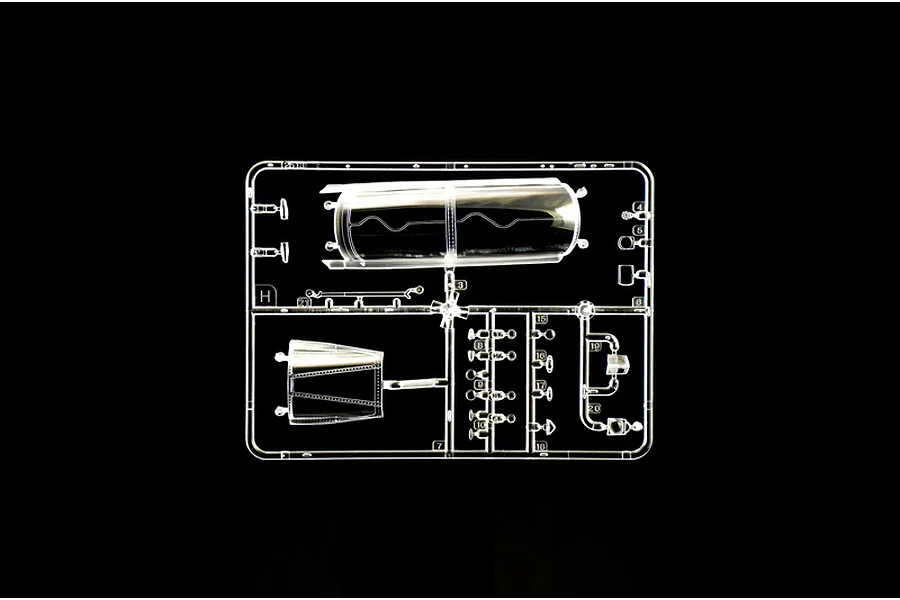 Clear plastic model kit sprue containing aircraft canopy and transparent parts set against a black background.