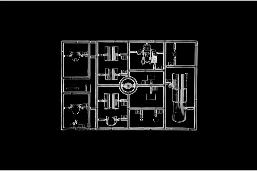 Clear plastic model sprue featuring transparent canopy and cockpit parts against a black background.
