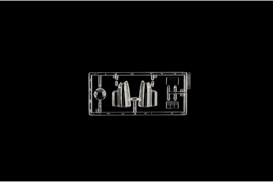 Clear plastic model kit sprue containing transparent canopy and window parts on a black background.