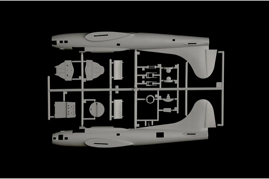 Grey plastic model kit sprue showing fuselage halves and interior parts for a B-17F Flying Fortress bomber against a black background.