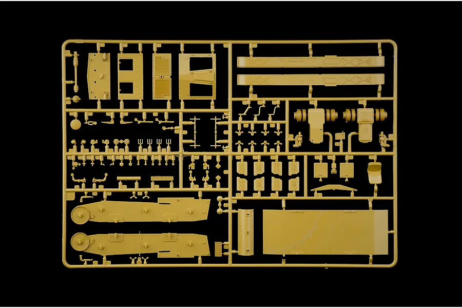 Tan plastic model kit sprue containing various parts for a military vehicle against a black background.