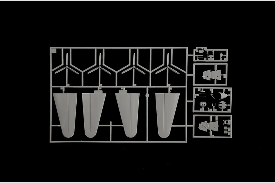 Grey plastic model kit parts sprue featuring four propellers and control surfaces on a black background.