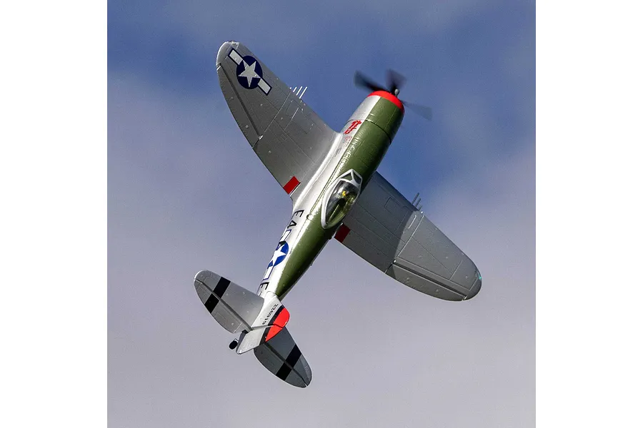 E-Flite Micro P-47 Thunderbolt RC warbird in flight against a blue sky, viewed from below.