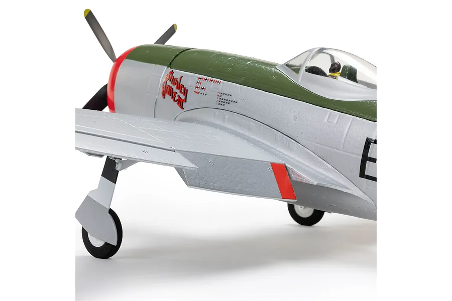 Close-up studio view of the E-Flite Micro P-47 Thunderbolt RC warbird showing the nose section, cockpit, propeller, and landing gear against a white background.