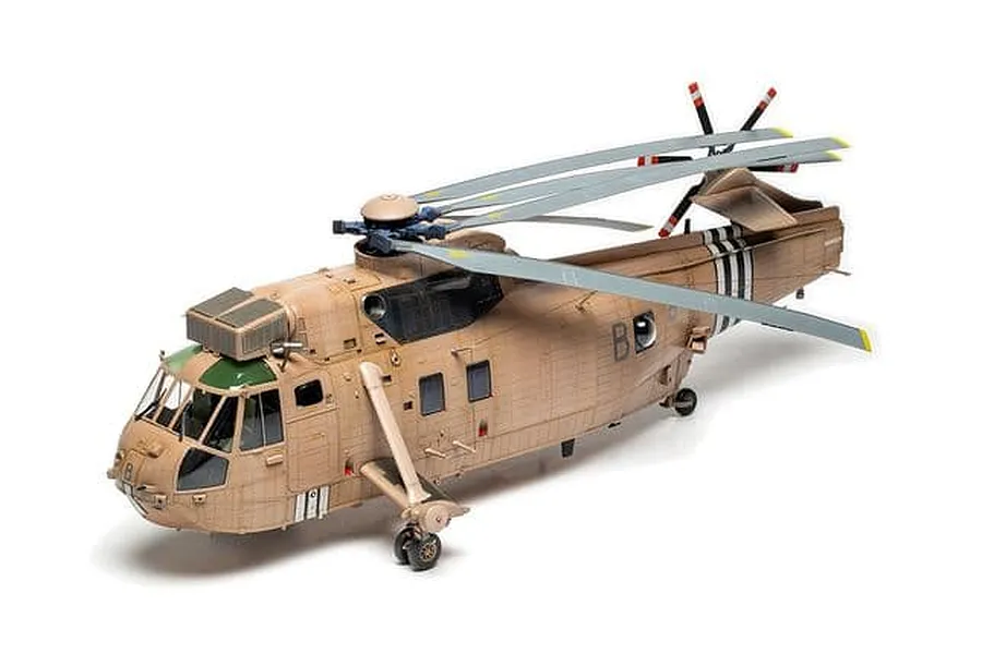 A completed and painted 1/48 scale model of a Westland Sea King HC.4 military helicopter in desert camouflage.