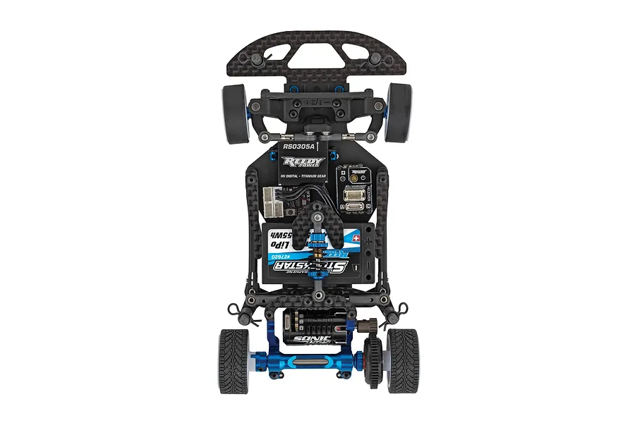 Top-down studio view of the chassis layout of an electric RC car showing carbon fiber, electronics, and blue aluminum parts.