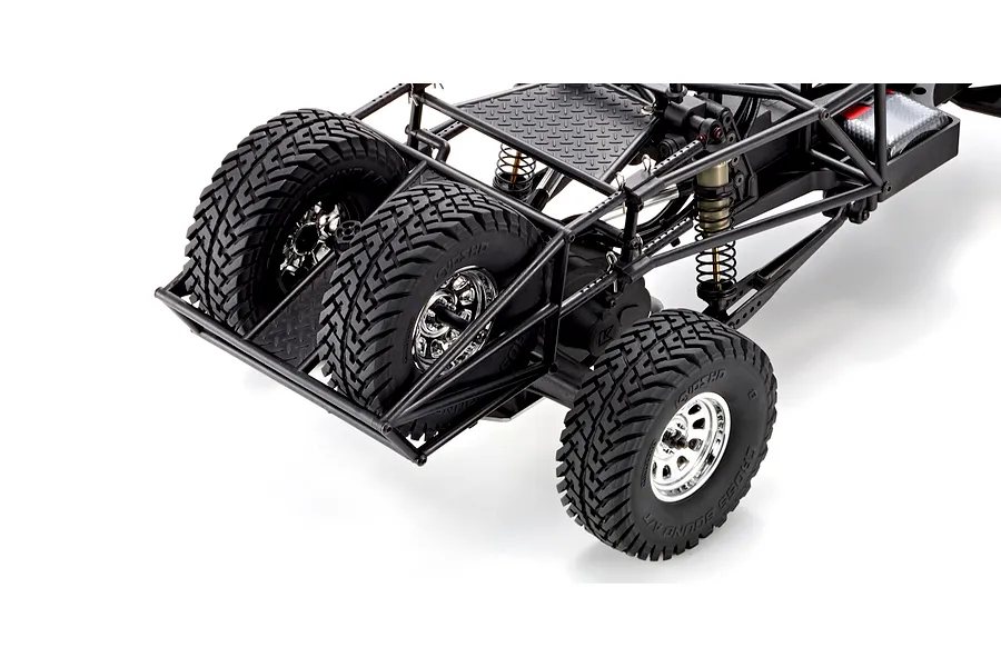 Close-up studio view of the rear tubular roll cage and spare tires on the Kyosho Outlaw Renegade RC truck.