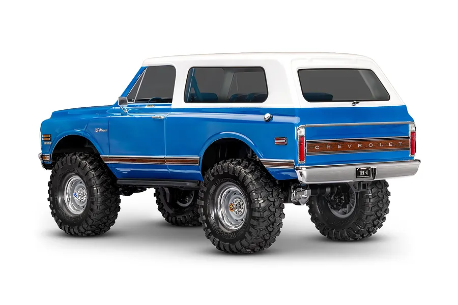 Rear three-quarter studio view of the blue Traxxas TRX-4 Chevrolet Blazer RC rock crawler with a white roof.