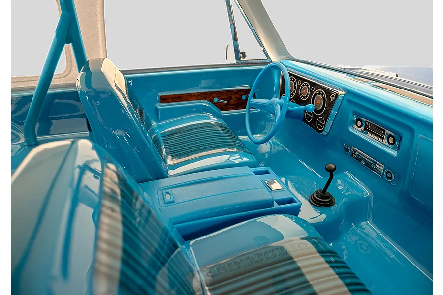 Close-up of the detailed blue interior of the Traxxas TRX-4 Chevrolet Blazer RC rock crawler, featuring bucket seats, steering wheel, and dashboard.