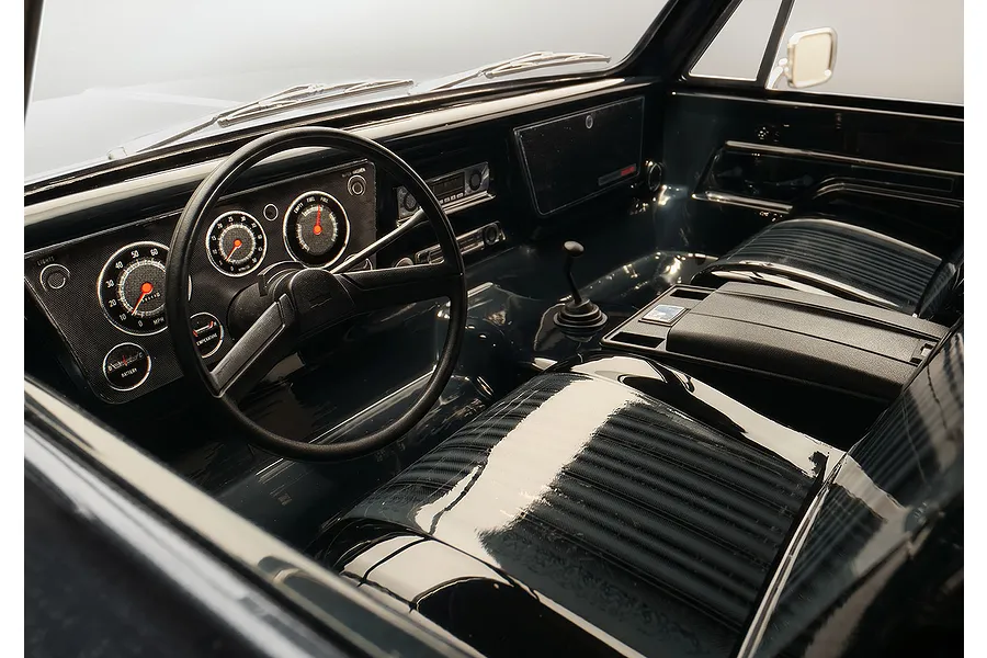 Detailed interior view of the Traxxas TRX-4 Chevrolet Blazer RC rock crawler showing dashboard, steering wheel, and seats.