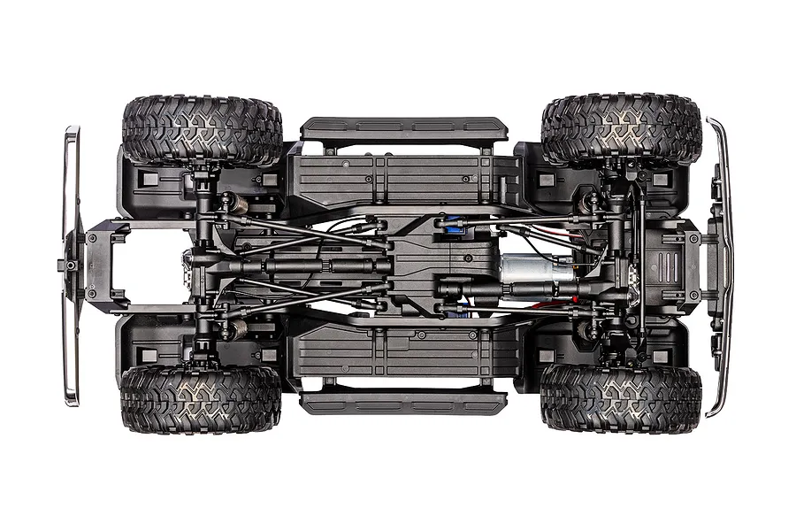 Bottom-up chassis view of the Traxxas TRX-4 RC rock crawler highlighting suspension links, frame rails, motor, and tires.