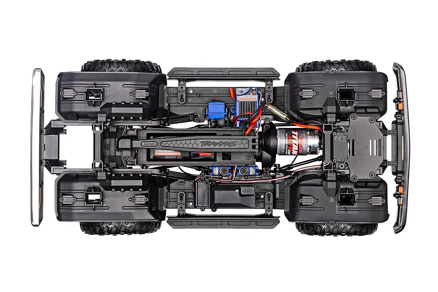 Top-down studio view of the chassis, motor, electronics, and interior frame layout of the Traxxas TRX-4 RC rock crawler.