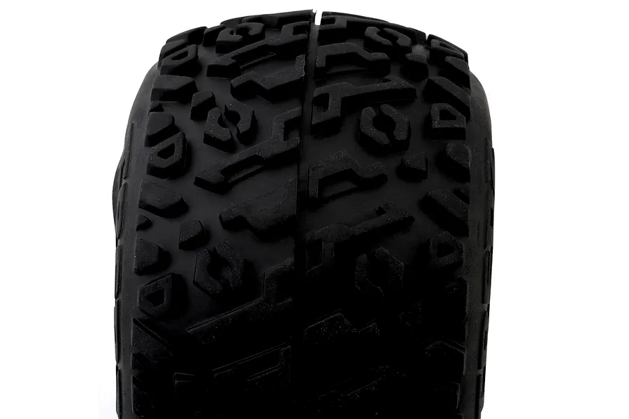 Close-up studio shot of a black RC monster truck tyre showing the tread pattern and rubber compound against a white background.