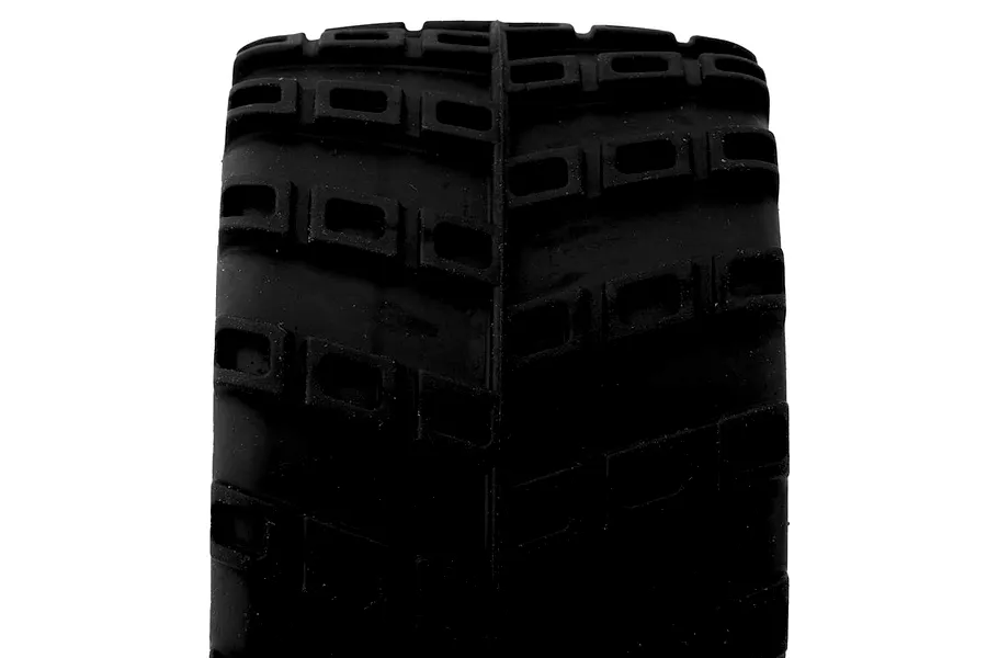 Close-up view of a black rubber RC truggy tyre tread with blocky tread pattern against a white background.