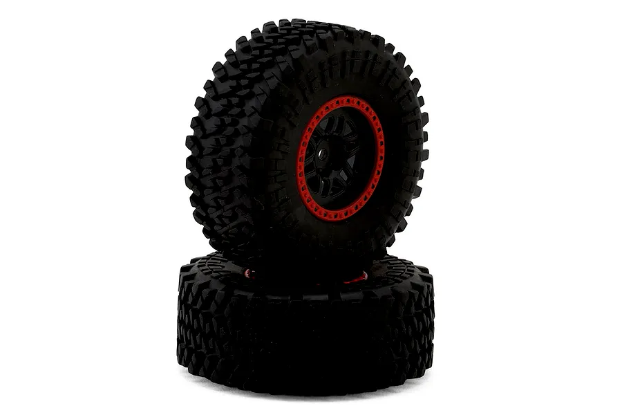 Two black RC crawler tires with aggressive tread mounted on black and red rims against a plain white background.