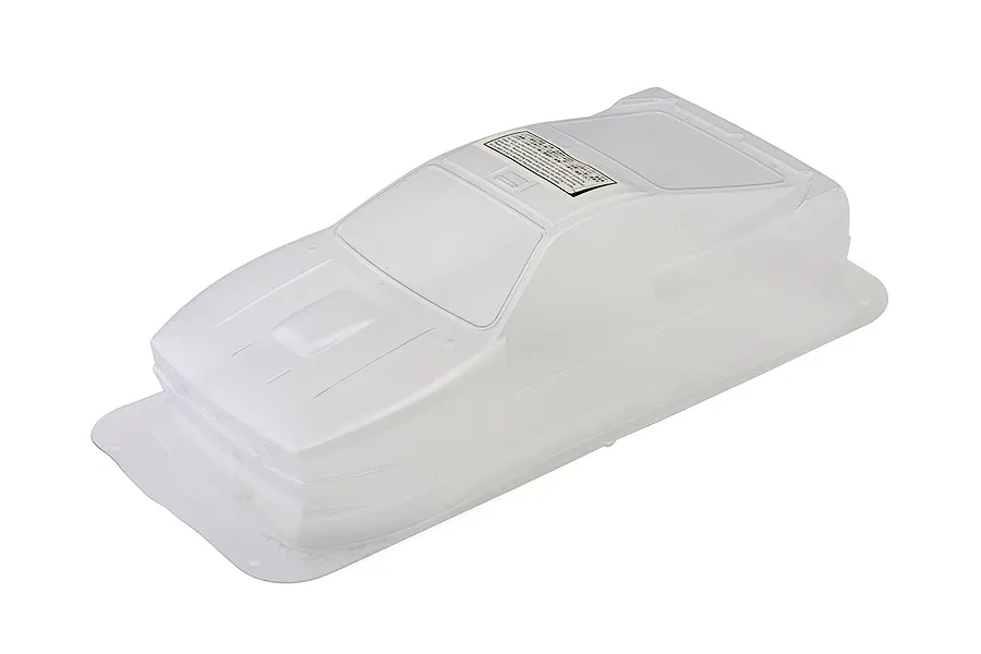 Unpainted clear polycarbonate RC rally car body shell on a plain white studio background.