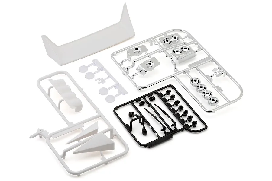 Unpainted plastic accessory parts and sprues for an RC rally car model on a white background.