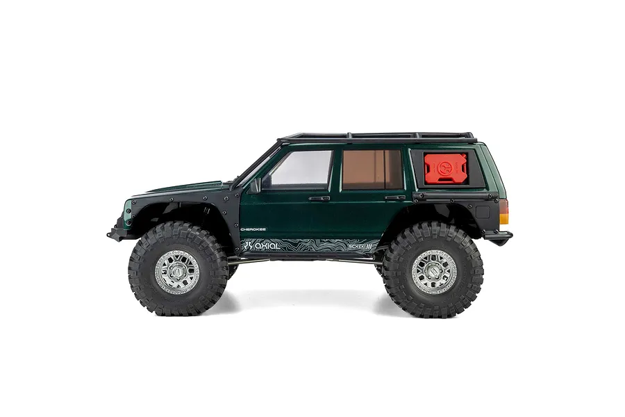 Studio profile view of the Axial SCX10 III Jeep Cherokee XJ RC rock crawler in green with roof rack and red jerry can.