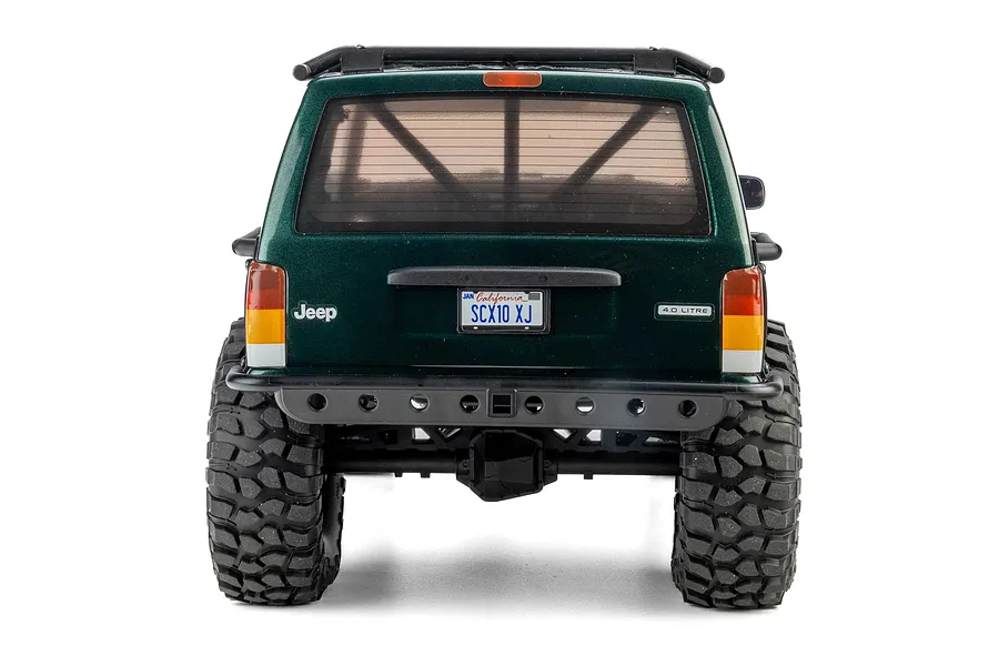 Rear view of the Axial SCX10 III Jeep Cherokee XJ RC rock crawler in green, highlighting the rear bumper, tail lights, and custom license plate.