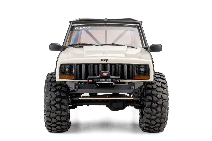 Front view of the white Axial SCX10 III Jeep Cherokee XJ RC rock crawler showing its grille, winch, and tires against a white background.